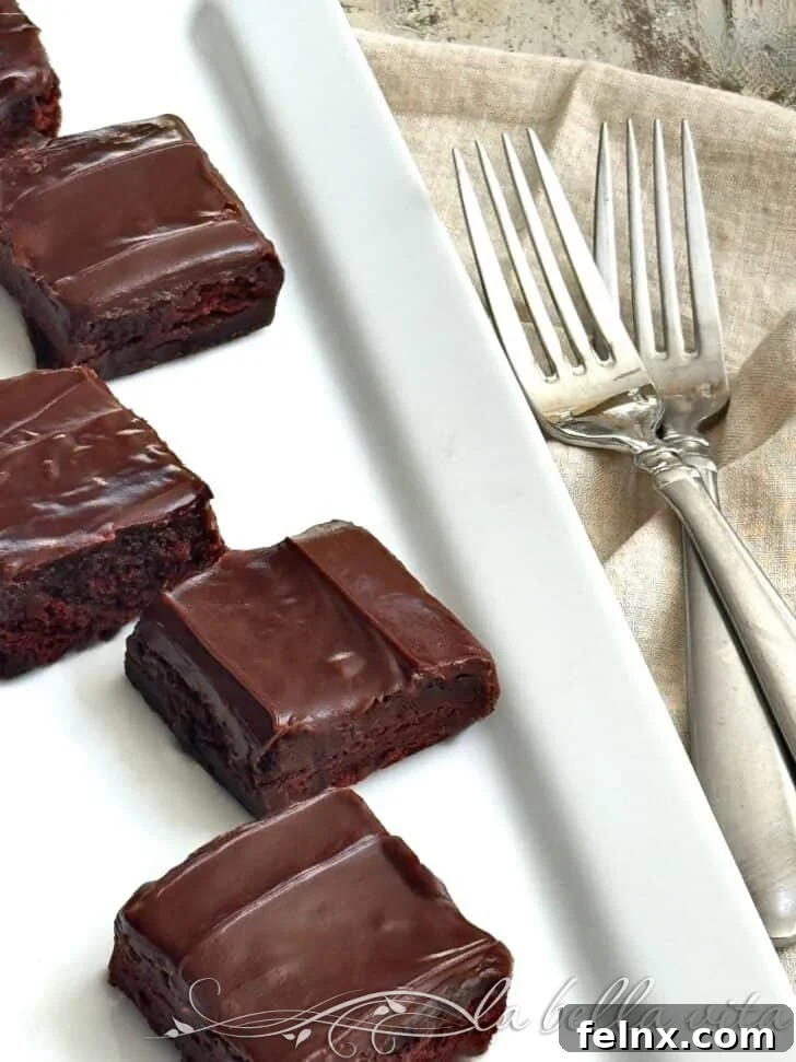 Brownie batter being spread into a baking pan
