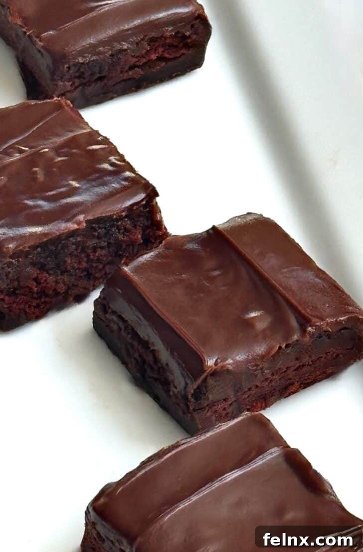Individual brownie squares stacked on a plate