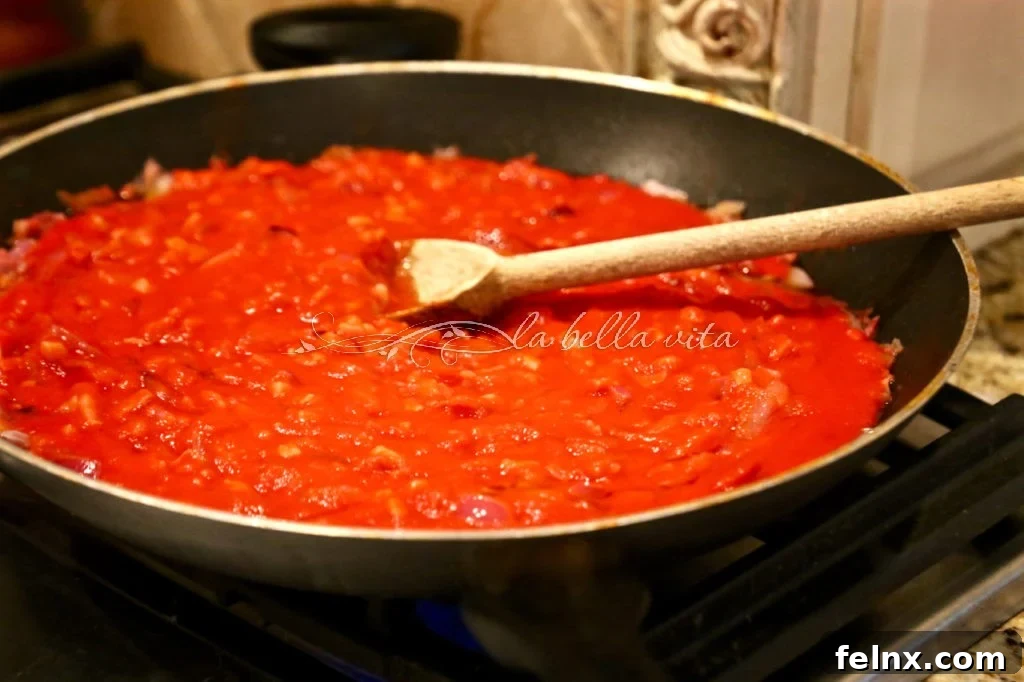 The tomato sauce simmering with pork and spices