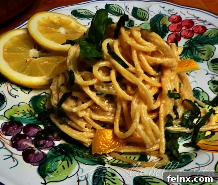 A beautifully plated dish of Pasta al Limone, garnished with fresh basil and lemon slices.