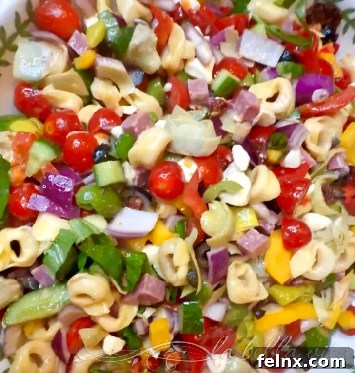 Delicious Italian Tortellini Pasta Salad with fresh vegetables and herbs