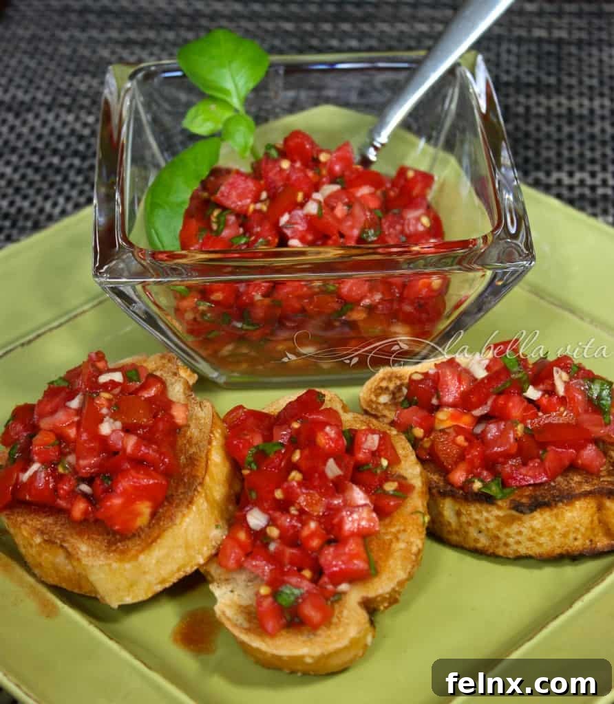Slices of toasted bread topped with fresh diced tomatoes and garlic